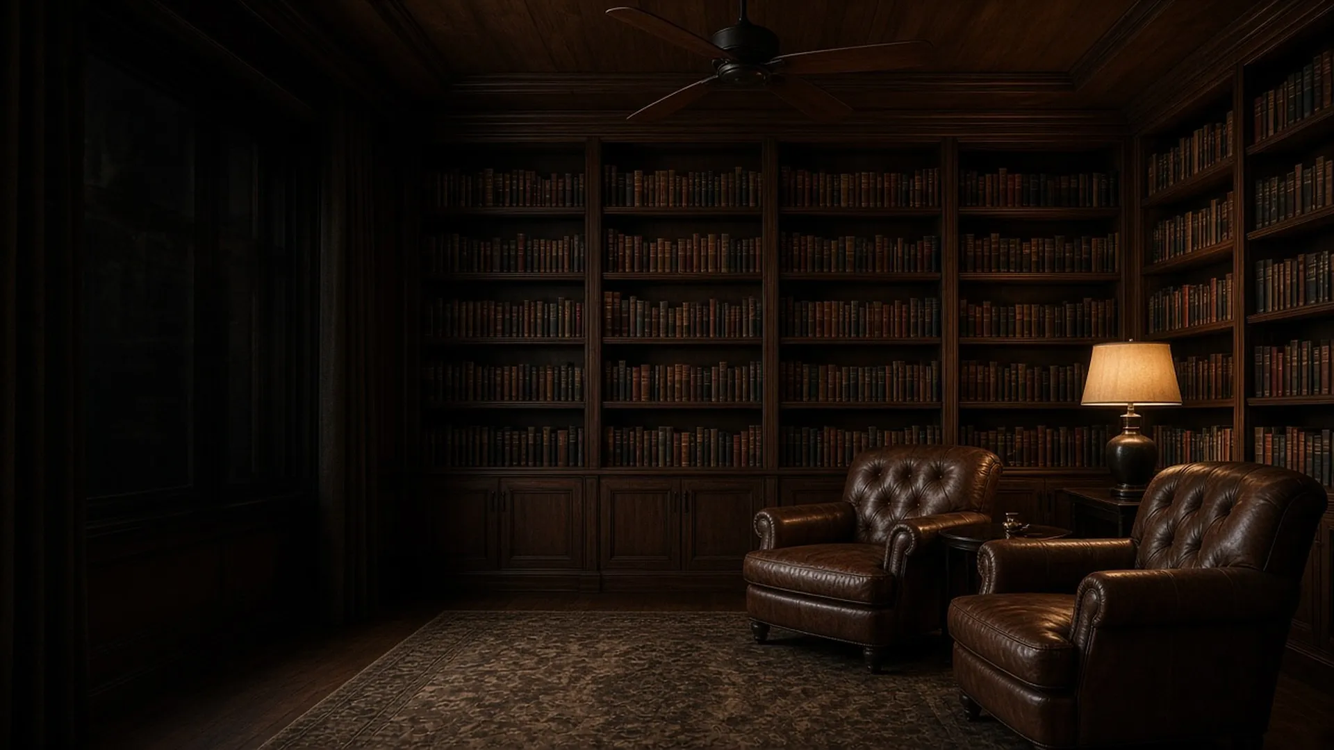 An empty library corner with a dark wood ceiling fan above leather chairs