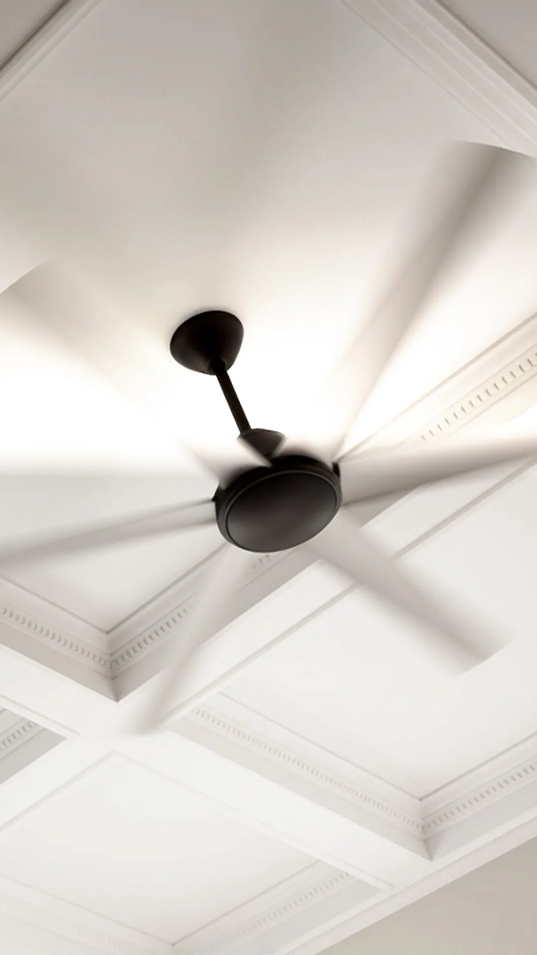 A ceiling fan seen from directly below